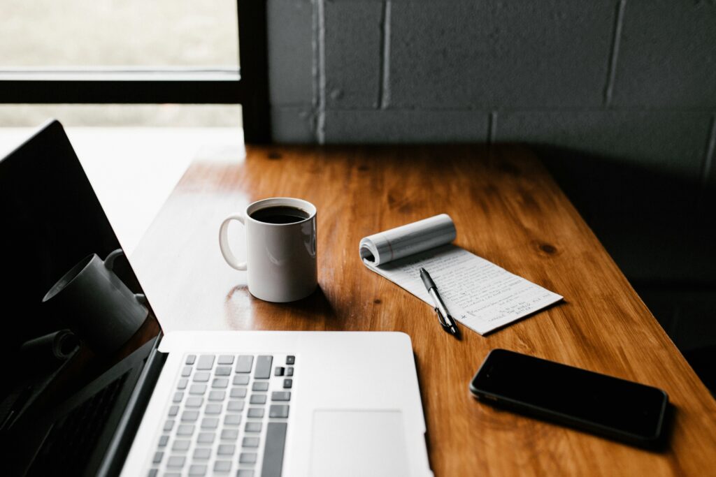 Writing desk with laptop and smartphone